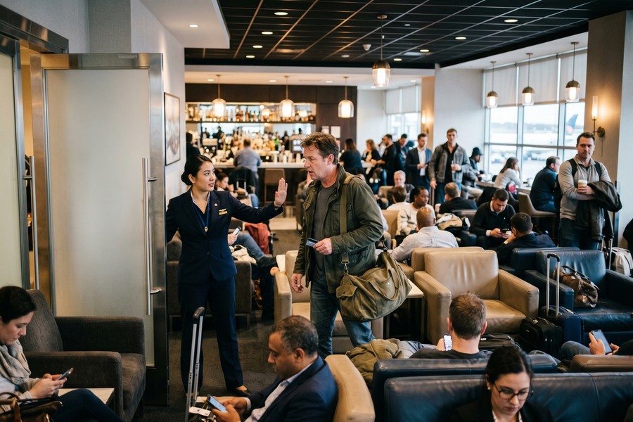 Family checking into an airport lounge using a travel rewards card at the reception desk