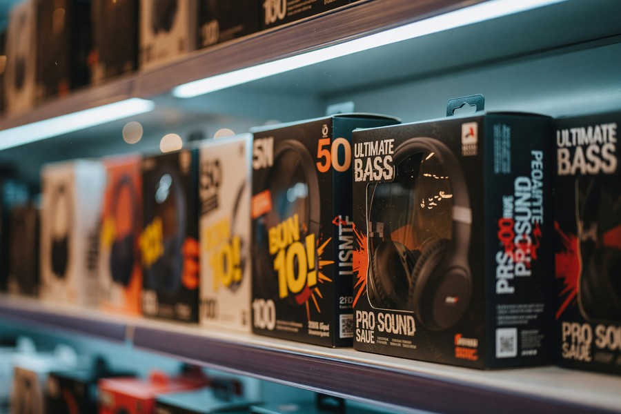 Four top noise-canceling headphones under $150 laid out side by side on a desk