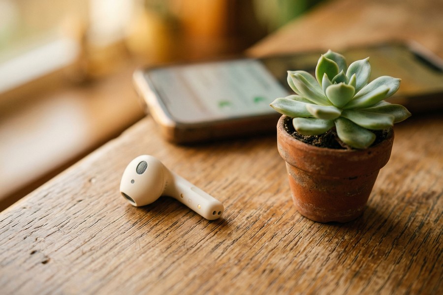 Close-up of wireless earbuds being placed into a compact charging case
