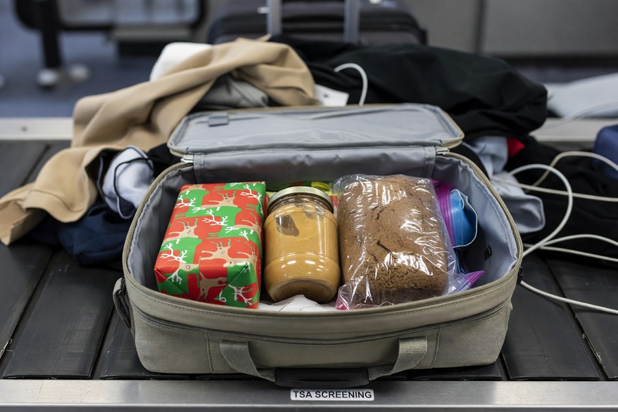 Organized carry-on bag with clear liquids pouch, laptop, and packing cubes ready for airport security