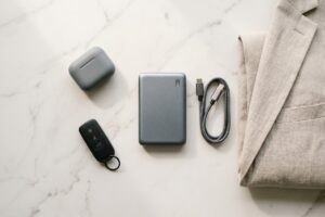 Minimalist portable charger placed next to a smartphone on a clean desk