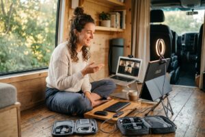 Remote teacher using a portable tech kit with laptop and accessories at a cafe