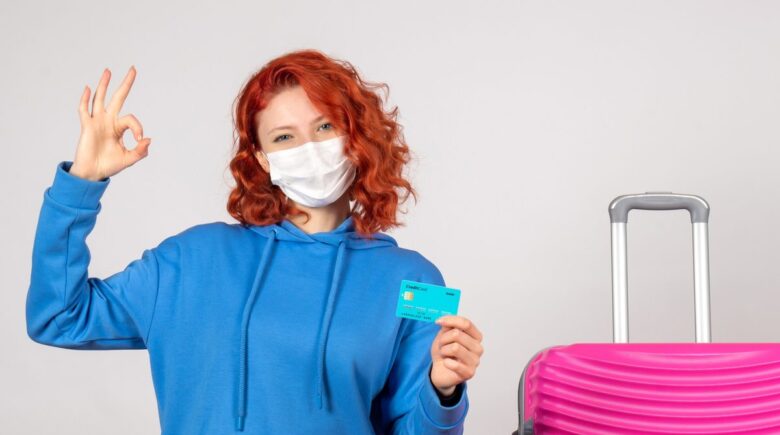 Traveler using a credit card abroad with a focus on avoiding common mistakes