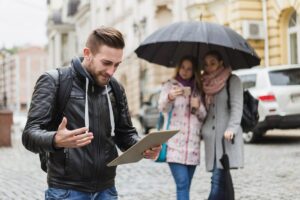 Person using smartphone app showing AI-powered packing list with live weather data displayed on screen