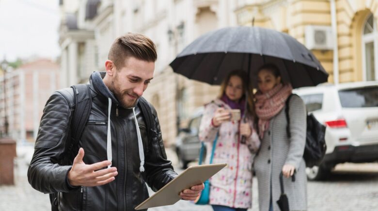 Person using smartphone app showing AI-powered packing list with live weather data displayed on screen
