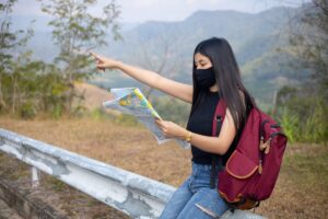 Backpacker using a biometric pouch and hotel safe to store cash securely while traveling in Southeast Asia