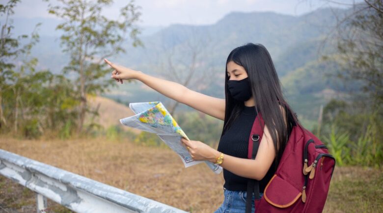 Backpacker using a biometric pouch and hotel safe to store cash securely while traveling in Southeast Asia