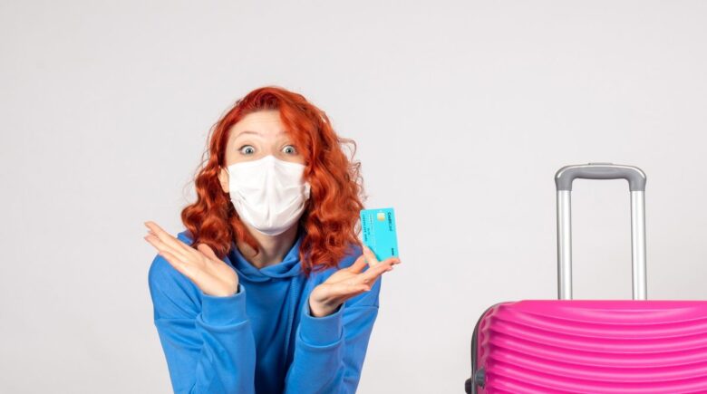 A traveler refilling a foldable water bottle after passing through airport security