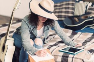 A travel journal with a built-in phone stand open on a plane seat