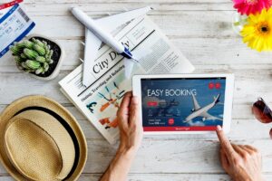 A person booking a flight to Bali with a laptop, showing a calendar with highlighted dates