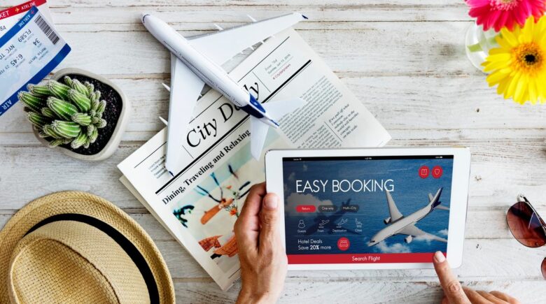 A person booking a flight to Bali with a laptop, showing a calendar with highlighted dates