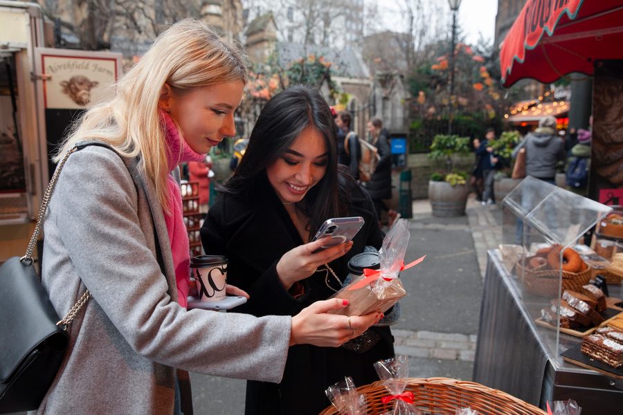 Customer adding a digital loyalty pass to their Apple Wallet at a local retail store