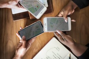 GPS luggage tag attached to a suitcase showing live location tracking on a smartphone