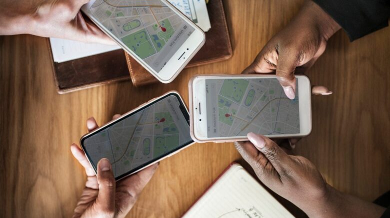 GPS luggage tag attached to a suitcase showing live location tracking on a smartphone