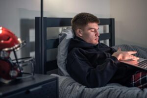 Grad student wearing a budget wearable device while studying and tracking wellness metrics