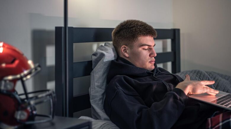 Grad student wearing a budget wearable device while studying and tracking wellness metrics