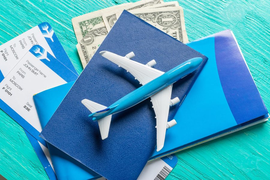 Traveler booking a multi-airline trip using a laptop with flight info overlay