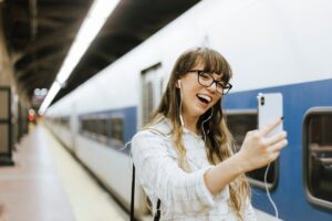 A traveler using free Wi-Fi at a Paris train station