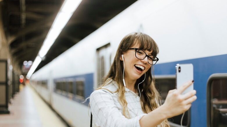 A traveler using free Wi-Fi at a Paris train station