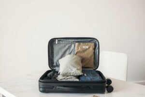 A person packing a 7-inch carry-on with compression sacks for a 7-day trip
