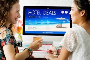 A person holding a hotel keycard with a rooftop view, smiling
