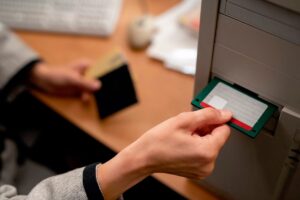A traveler using a RFID-blocking travel wallet to secure cash and cards