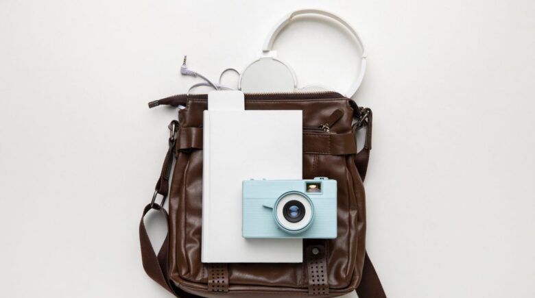 Overhead view of a 30L travel backpack open showing separated laptop sleeve and padded camera cube compartments