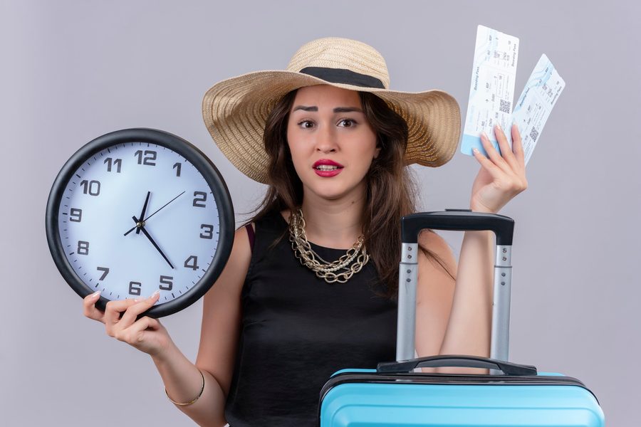 Traveler looking at a hidden-city flight option on a smartphone with a warning icon visible
