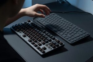 Side-by-side comparison of a mechanical keyboard and membrane keyboard on a desk