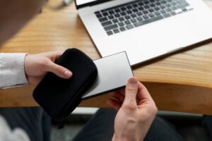 A phone credit card case holding a phone, credit card, and ID with a sleek, modern design