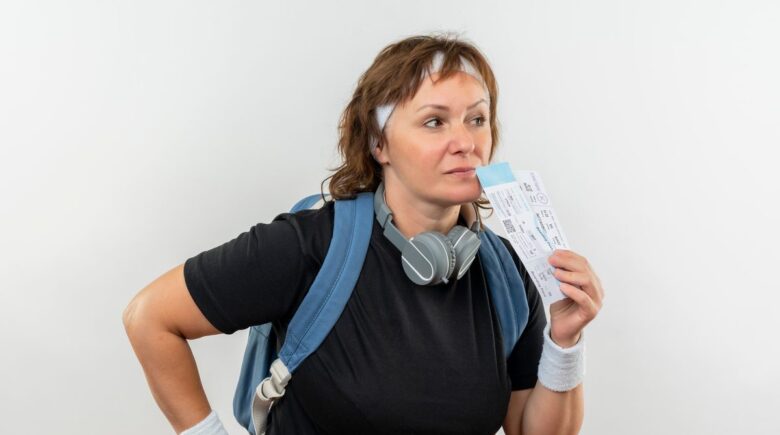 Portable digital smart scale displaying luggage weight with smartphone app open showing airline baggage limits