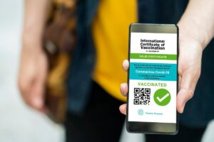QR code luggage tag attached to travel bag at airport check-in counter