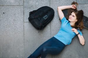 Compact memory foam travel pillow compressed into a small backpack front pocket