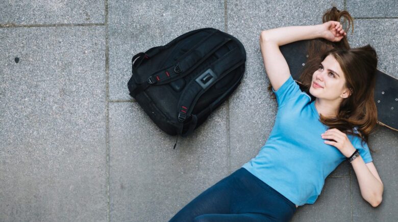 Compact memory foam travel pillow compressed into a small backpack front pocket