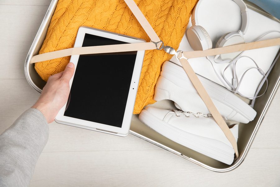 Image: Close-up of a smart mirror embedded in a suitcase lid, showing a digital overlay of checked items