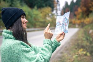 Traveler using AI-powered navigation app and smart luggage with GPS tracker at airport