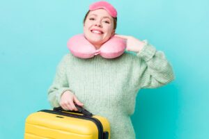 Crew sock filled with rice shaped into a neck pillow on an airplane armrest