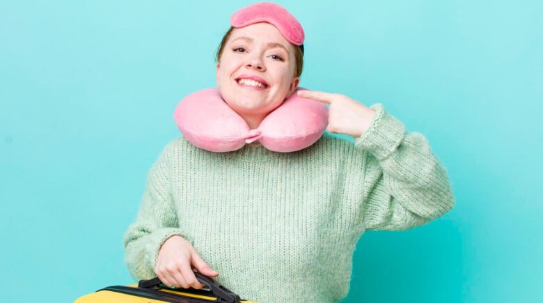 Crew sock filled with rice shaped into a neck pillow on an airplane armrest