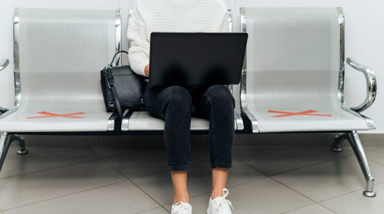 Passenger checking seat number on aircraft boarding gate
