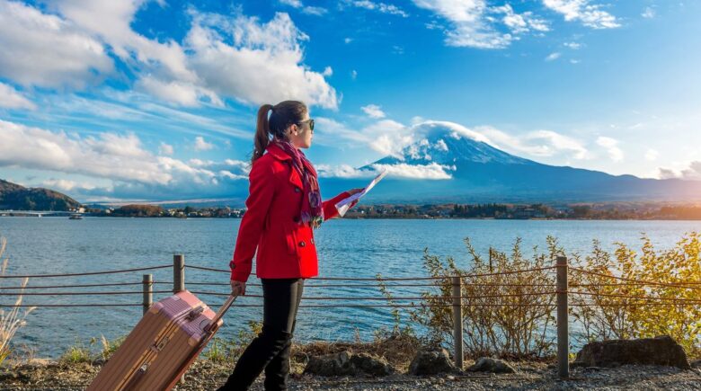 A traveler using a smartphone to book Japan trips without a travel agency