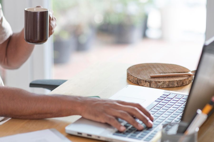 Freelancer working at an outdoor Austin cafe table with a minimalist gadget setup.